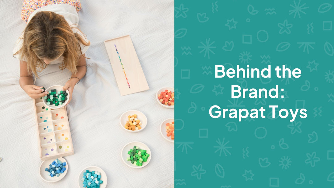 image of a young white girl with blond hair laying on the floor with a colourful wooden play set. The text on the image reads 'Behind the brand: Grapat toys' 