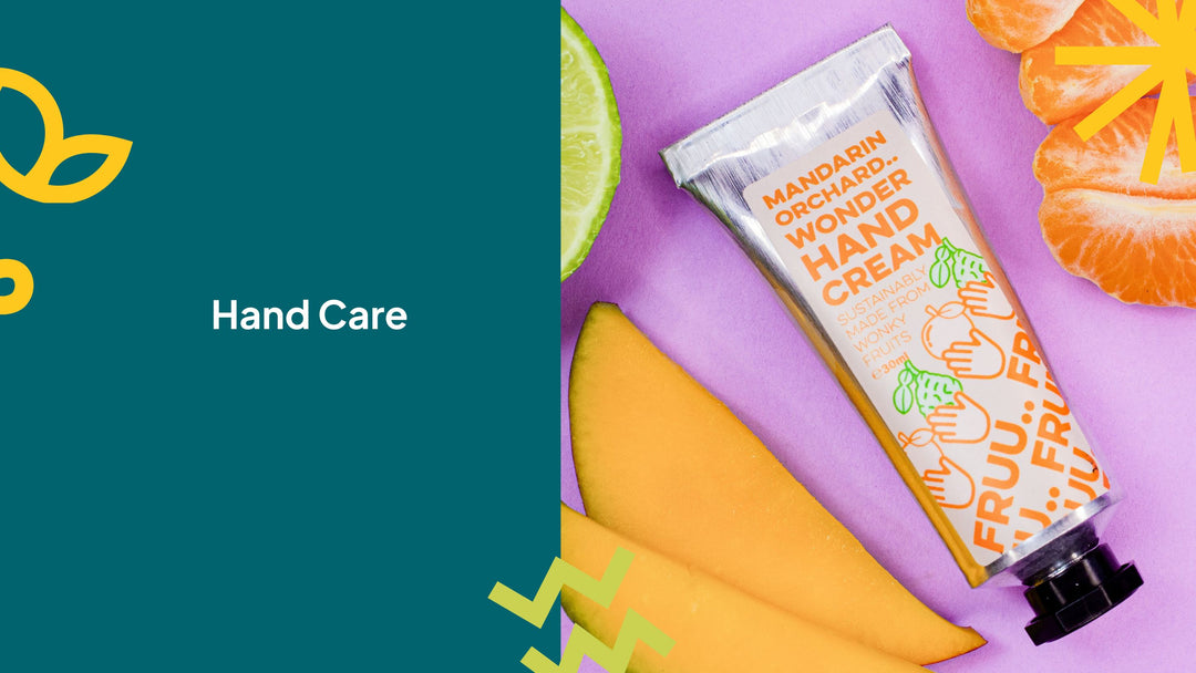 womans hand with pink nails holding an aluminium tin of pura mango and papaya hand balm. 