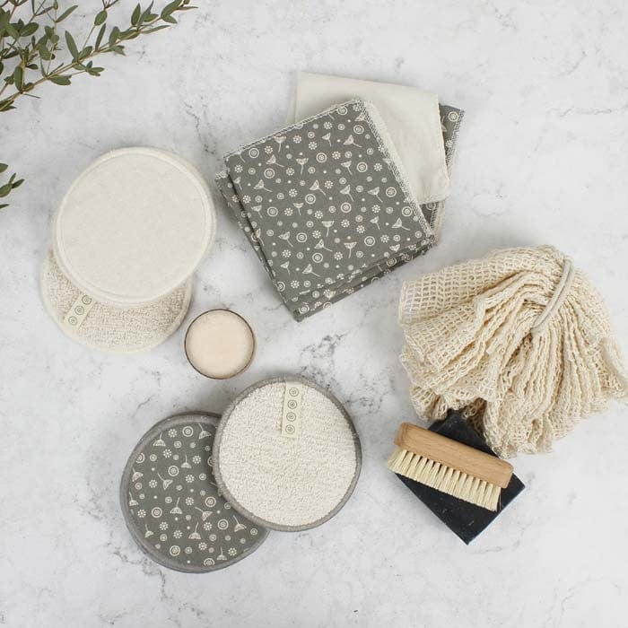 natural reusable face wipes, shower puff and cleansing pads on a neutral background