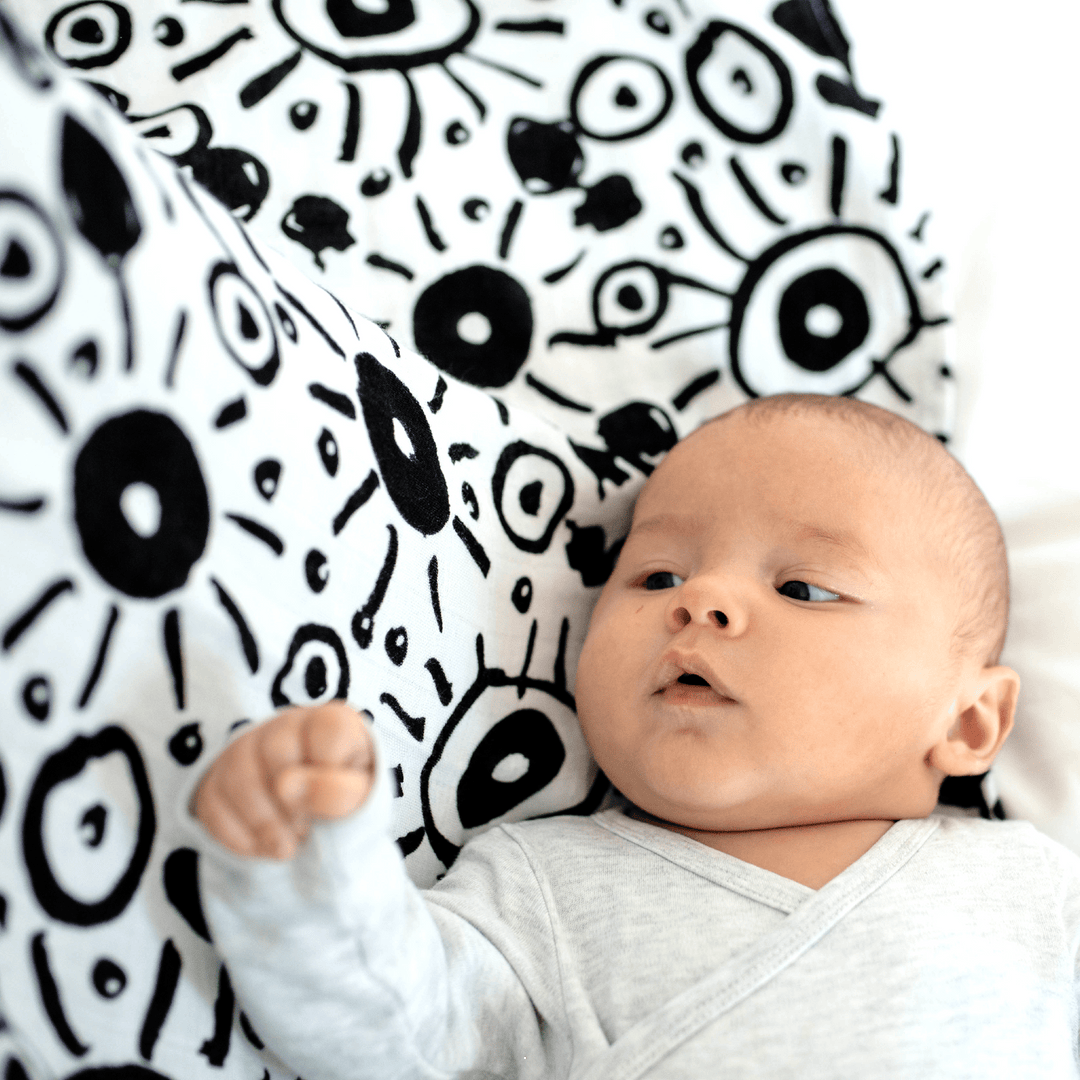 baby with black and white printed organic cotton sensory muslin made by Etta Loves