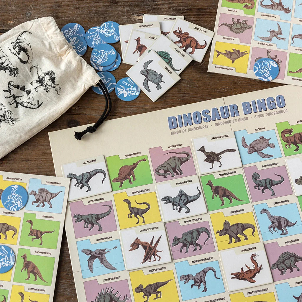 dinosaur bingo game on a wooden table