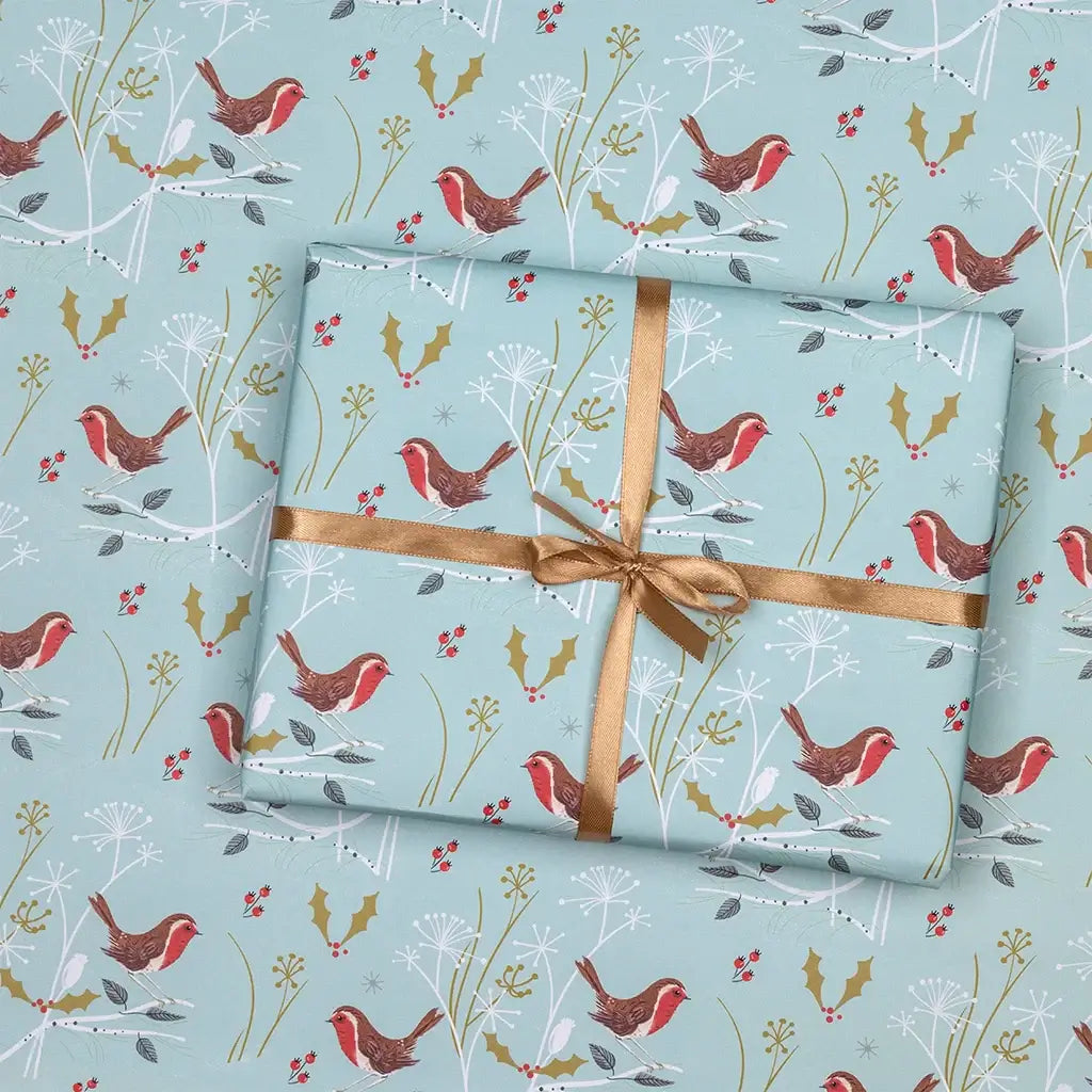 Christmas wrapping paper with a blue background and festive robin print