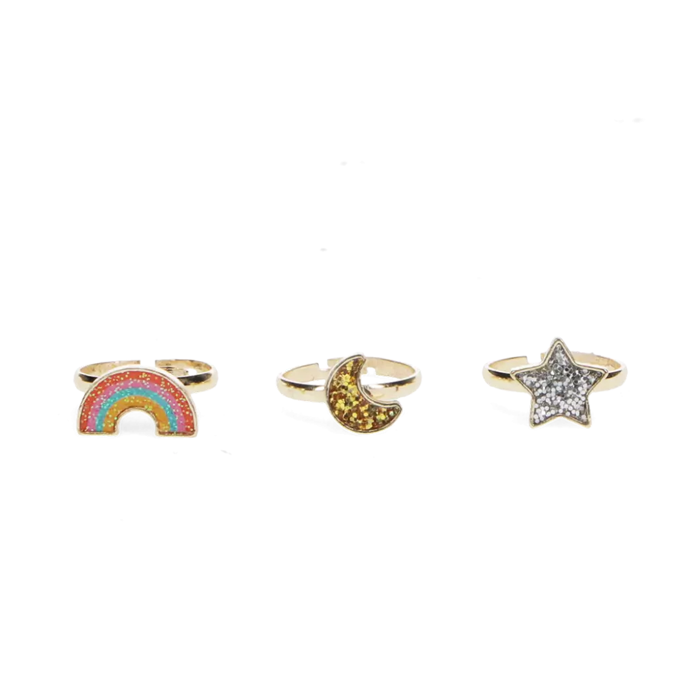 three children's glitter rings - rainbow, moon and star shapes - in a row on a white background. The rings are adjustable and have a gold band. 