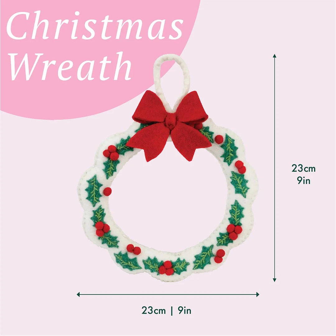Christmas wreath with a red bow on a pink background