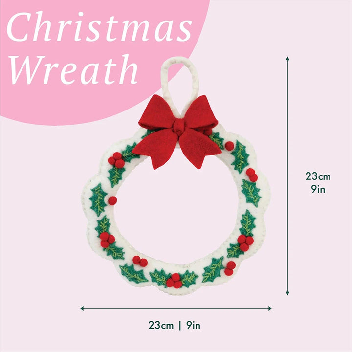 Christmas wreath with a red bow on a pink background