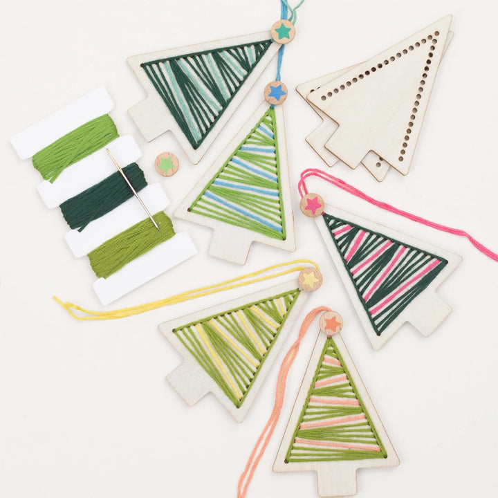 Decorative Christmas tree ornaments with colorful string patterns on a white background