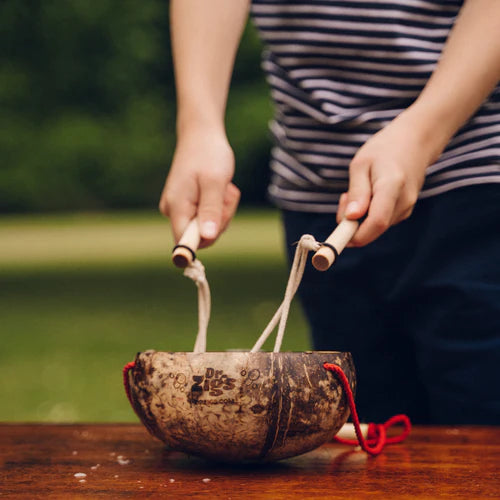 childs hands playing with dr zigs children's bubble kit with coconut bucket and giant wooden wand for making giant bubbles.