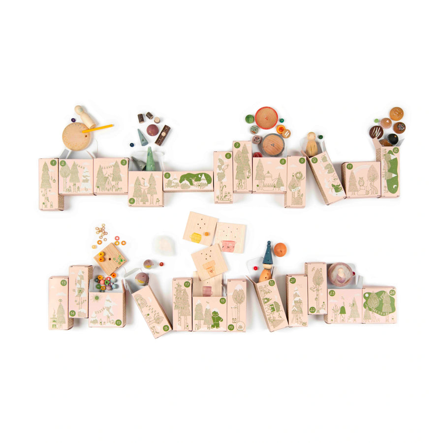 24 small boxes from a reusable advent calendar with wooden loose parts and play figures peeking out of the top.  The toys are on a white background