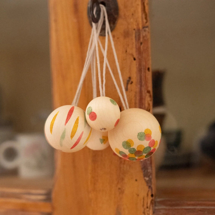 Set of 5 'wonder balls' wooden christmas decorations hand painted with colourful stripes and spots.  