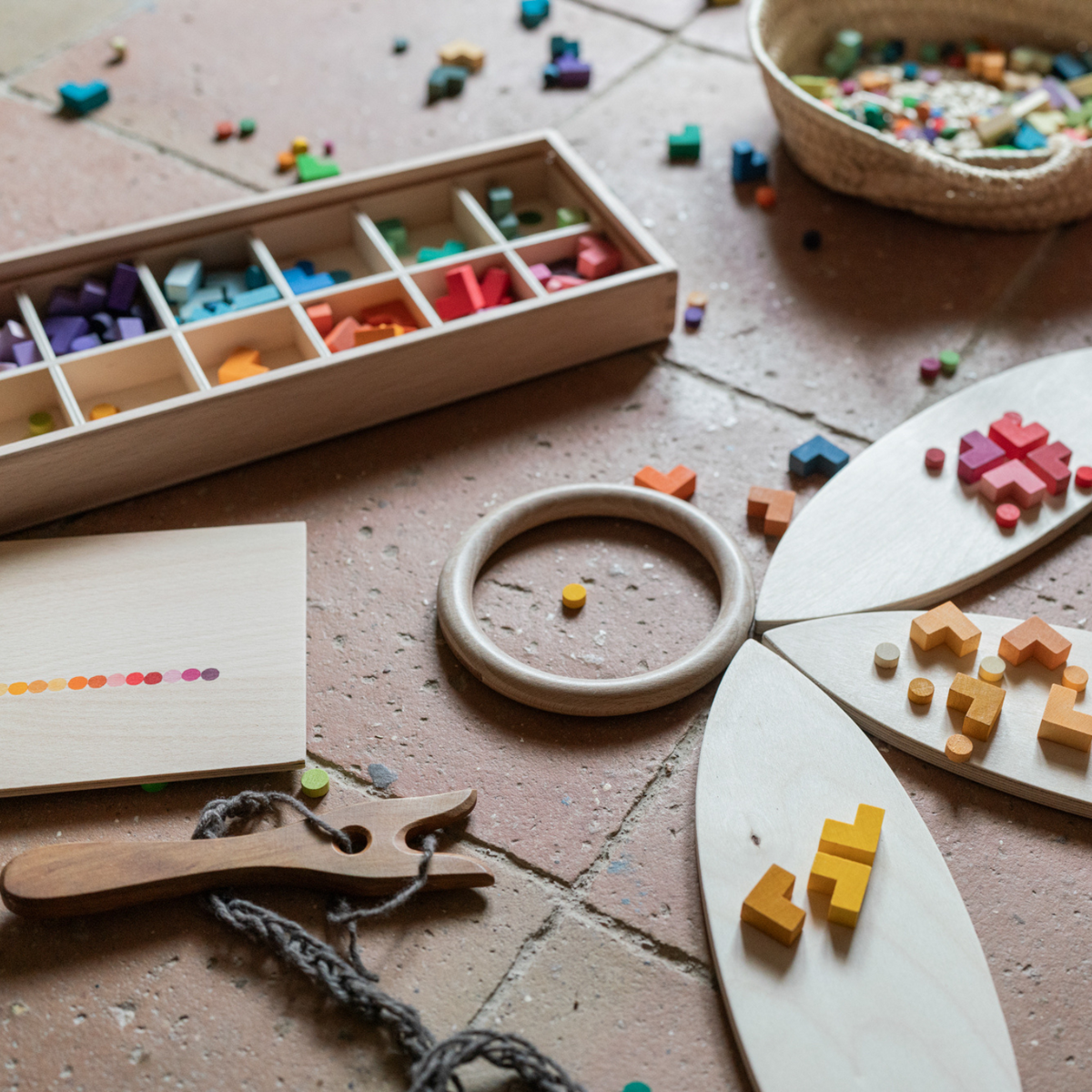mis and match wooden loose parts in rainbow colours with a wooden sorting box and wooden platforms for open ended play. For children aged 3 and over.