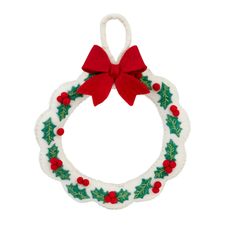 Decorative Christmas wreath with a red bow on a white background