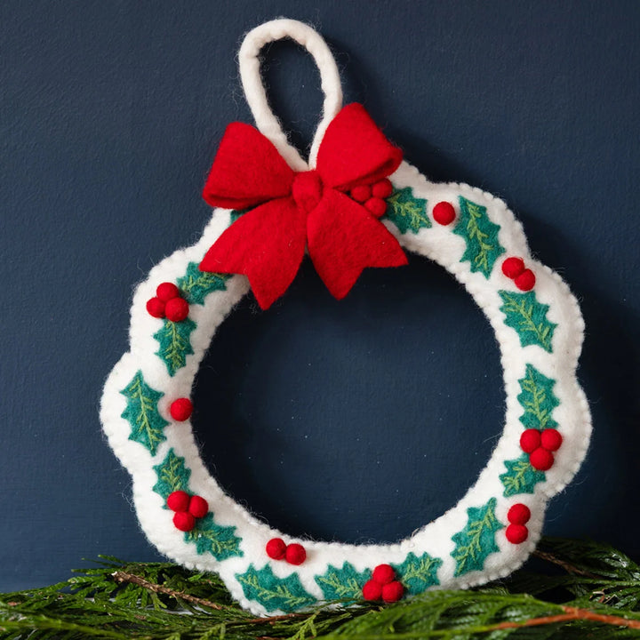Decorative Christmas wreath with a red bow on a dark blue background