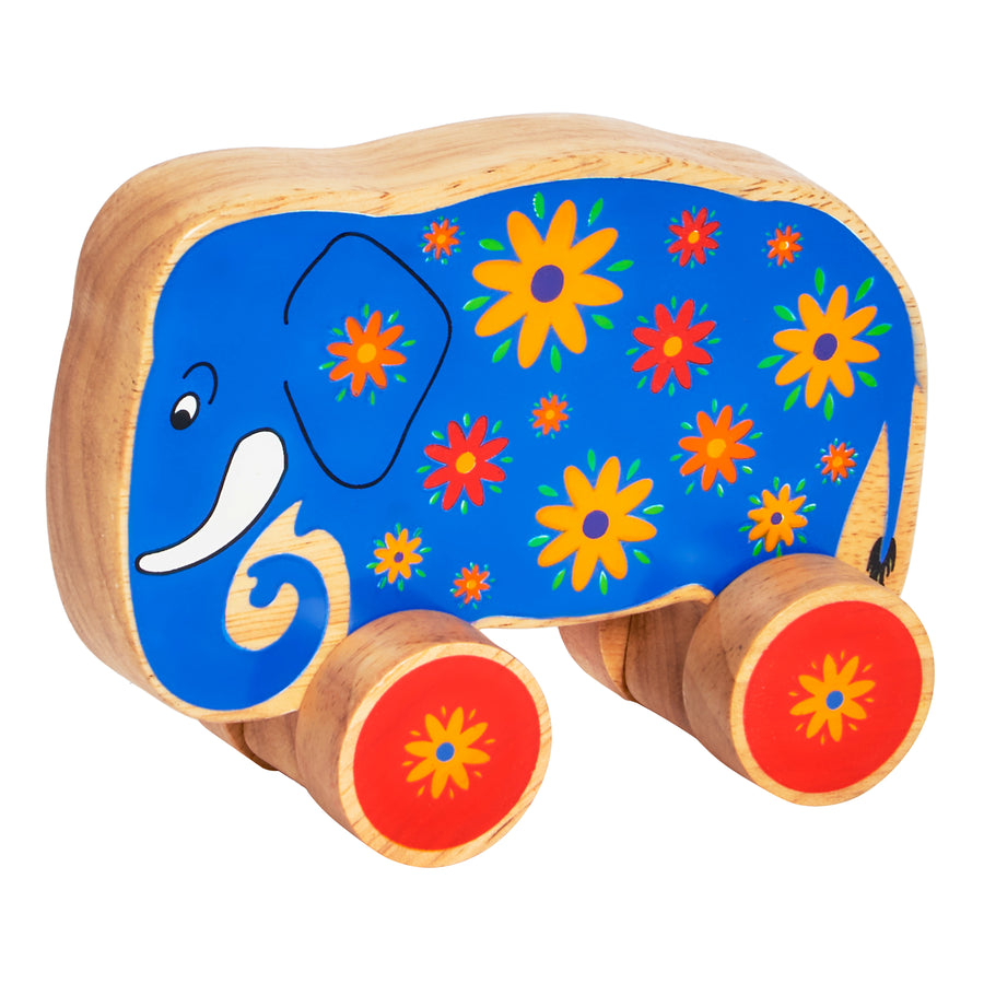 Lanka Kade 30th birthday limited edition push along elephant on wheels. The toy is made from rubber wood, painted blue with flower details and red wheels. Suitable for children from 10 months old. 