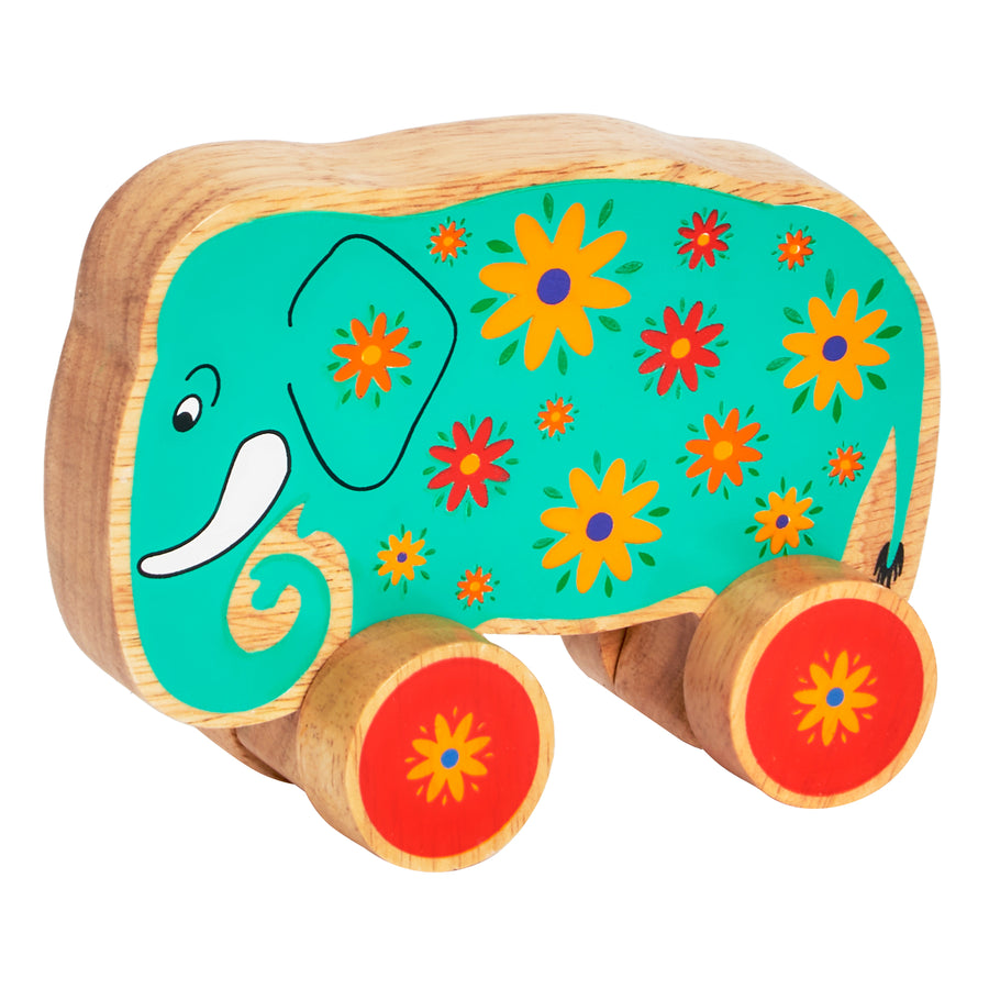 Lanka Kade 30th Birthday Green Elephant Push Along wooden toy with painted flower details and red wheels. Suitable for children from 10 months and over.