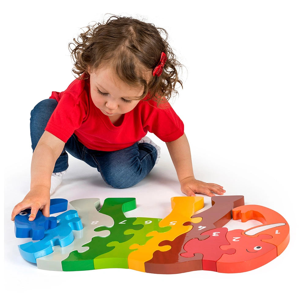 girls playing on the floor with a rainbow coloured Lanka kade wooden Jumbo elephant floor puzzle. For kids age 3 and over. 