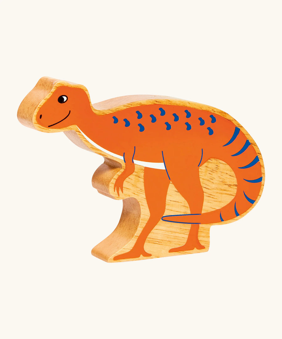 Wooden dinosaur toy figure on a white background