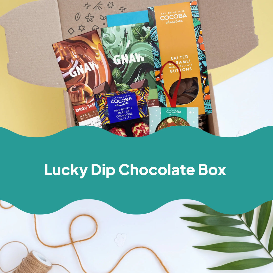 A curated chocolate box assortment displayed in an open kraft box with a teal banner reading &