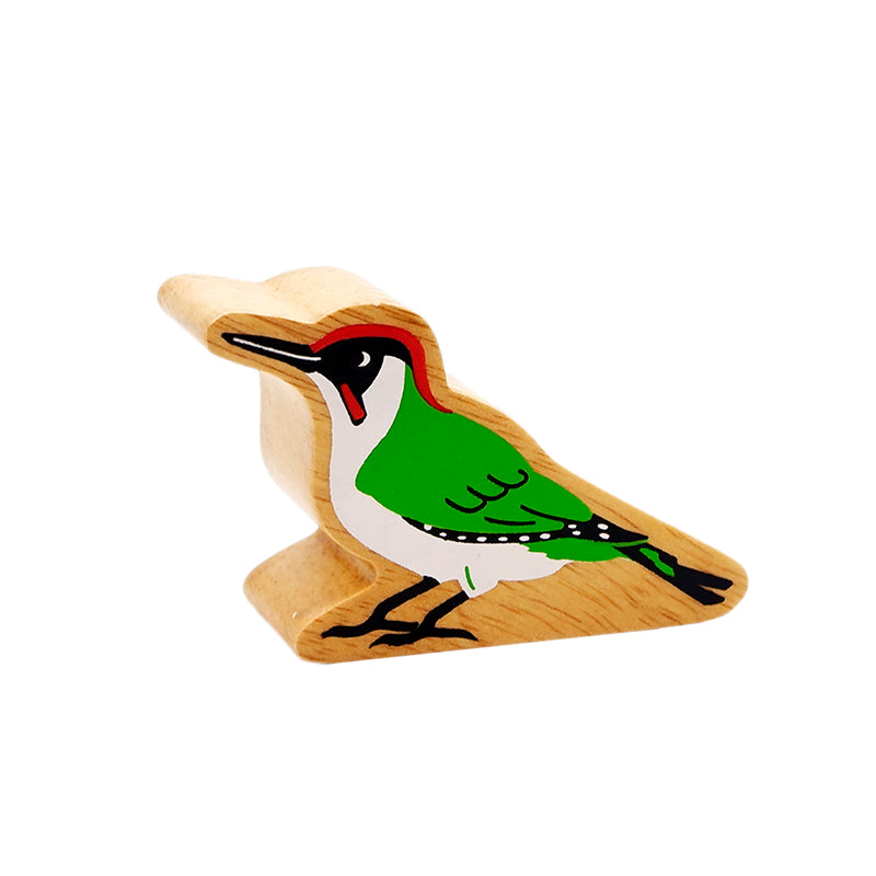 A wooden green woodpecker toy figure with red and white accents on its head and wings and a natural wood grain edge. 10 months+