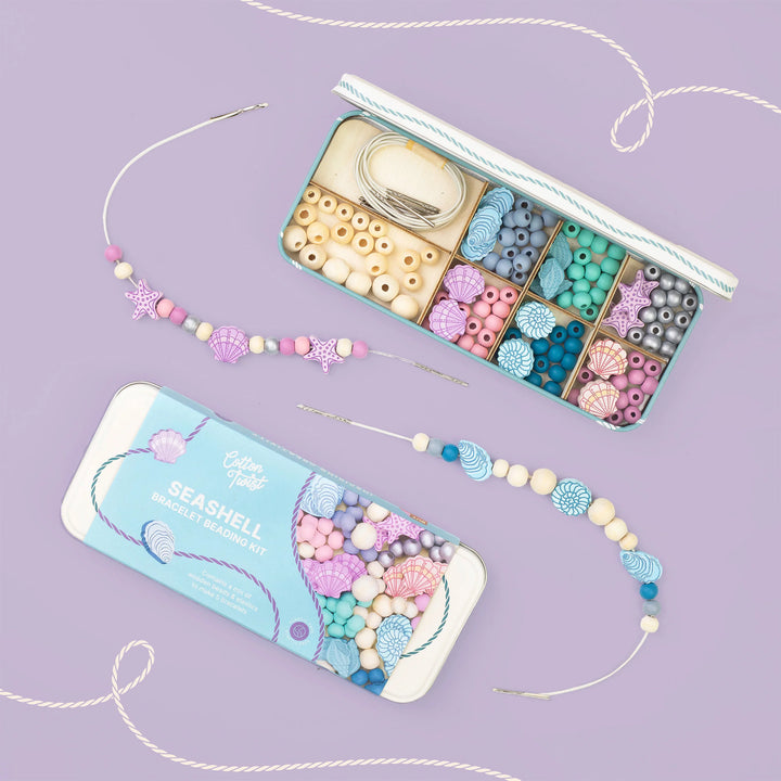 Beaded necklace set with packaging on a purple background