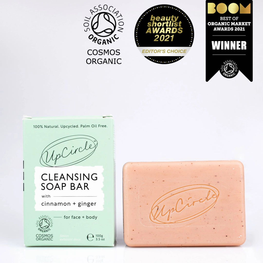 a bar of UpCircle Facial Cleansing Bar with the packaging and logos to show that it's organic and has won two beauty awards