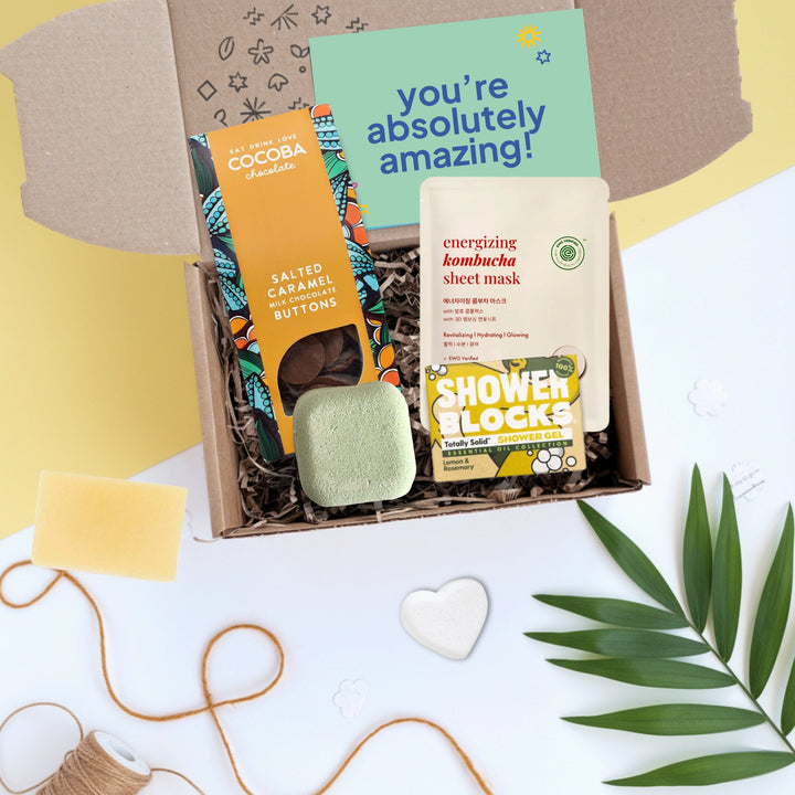 gift box filled with chocolate, shower steamer, face mask and a shower gel bar. The gift card reads ' you're absolutely amazing'