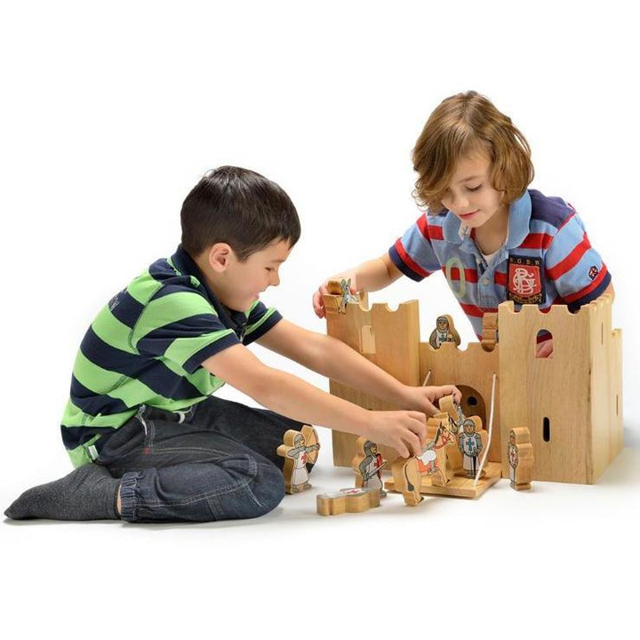 two children playing with a lanka kade wooden castle and wooden knights