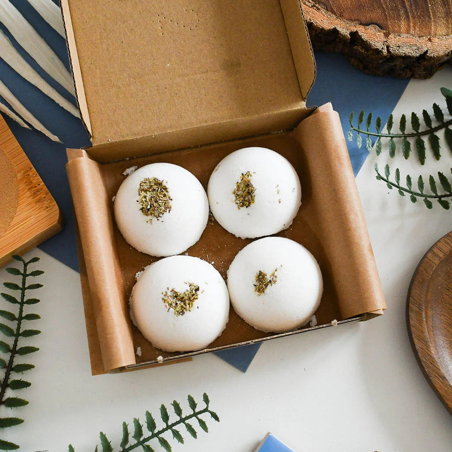 four aromatherapy shower steamers in a square gift box 