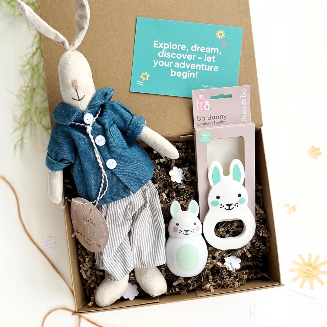 Gift box with plush rabbit toy, baby teether, and chiming bunny rattle featuring a gift card suitable for a new baby, baby shower or first birthday gift