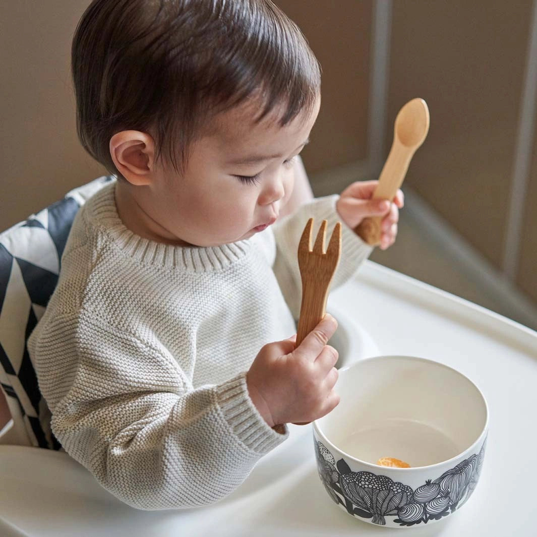 baby holding Kids Bamboo Fork + Spoon Set