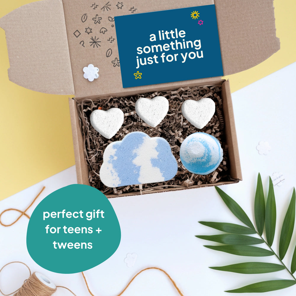 gift box with five bath bombs in the shape of hearts and clouds, on a yellow background with a card that reads ' a little something just for you'. Text reads 'perfect gift for teens and tweens'