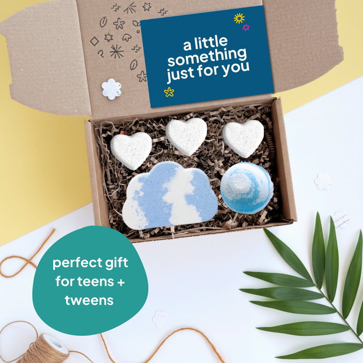 gift box with five bath bombs in the shape of hearts and clouds, on a yellow background with a card that reads ' a little something just for you'. Text reads 'perfect gift for teens and tweens'