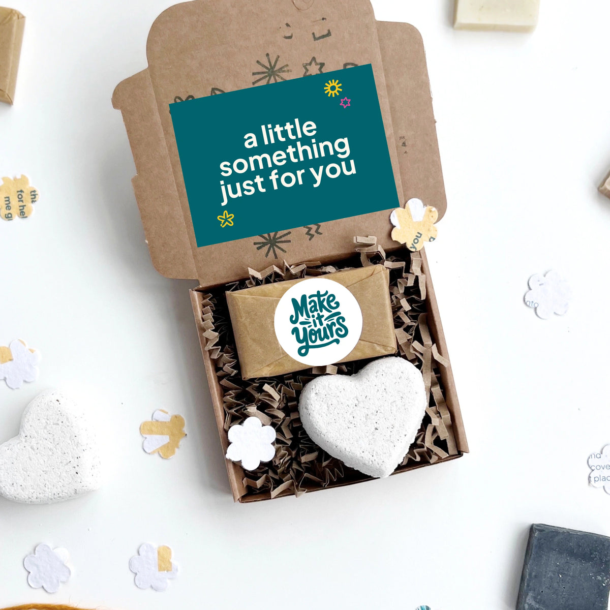 eco friendly client gift box with a heart-shaped bath bomb , mini soap bar with custom branding option and a gift card inside, on a white background.