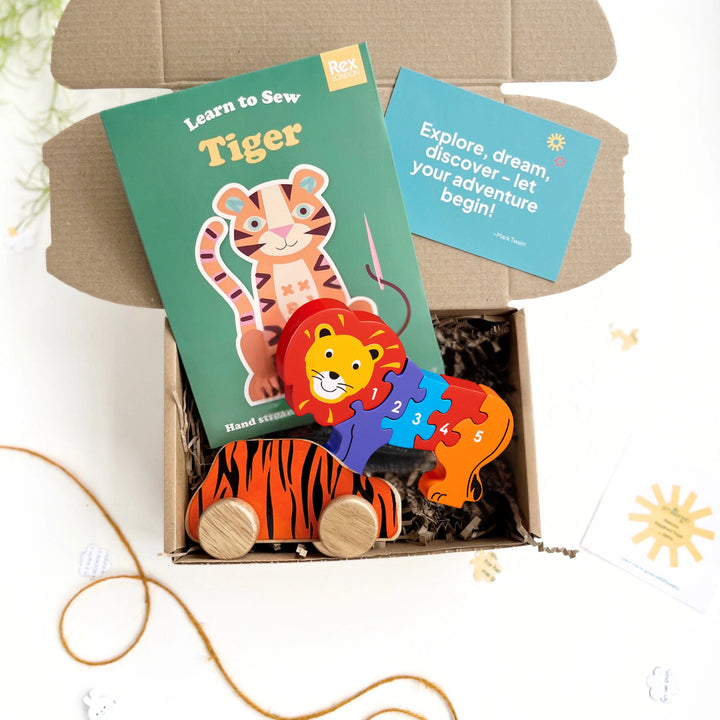 Children's lion and tiger themed educational toy set with craft kit, puzzle, and tiger car toy in a gift box.