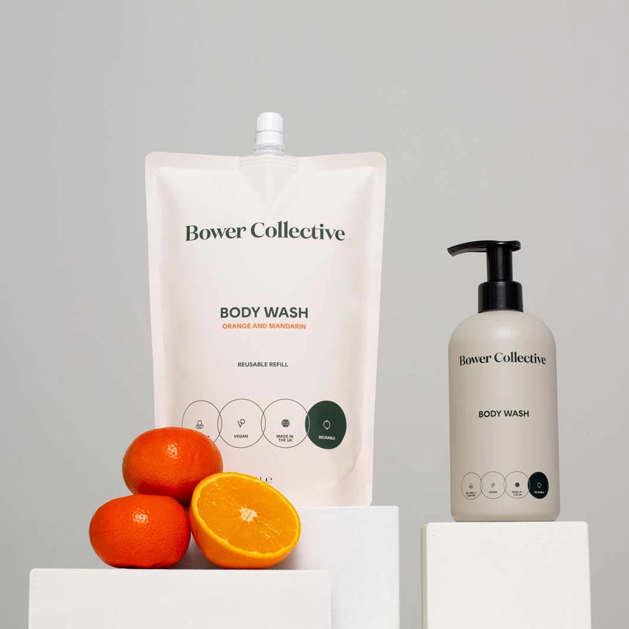 bower collective orange and mandarin body wash in a refillable pouch with a grey reusable pump bottle