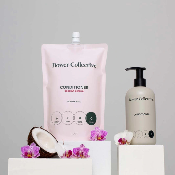 pink refill pouch with bower collective coconut and orchid conditioner for all hair types and a grey reusable pump bottle 