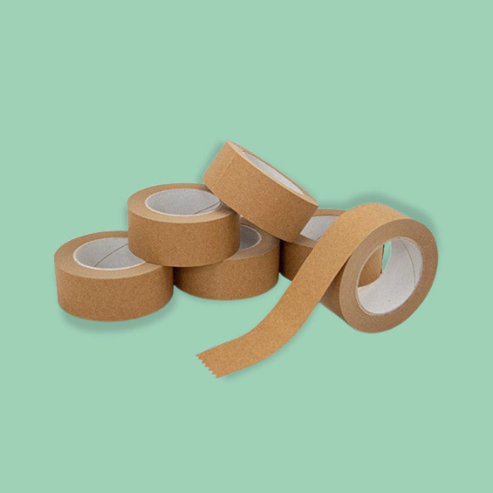 Brown paper tape rolls on a light green background