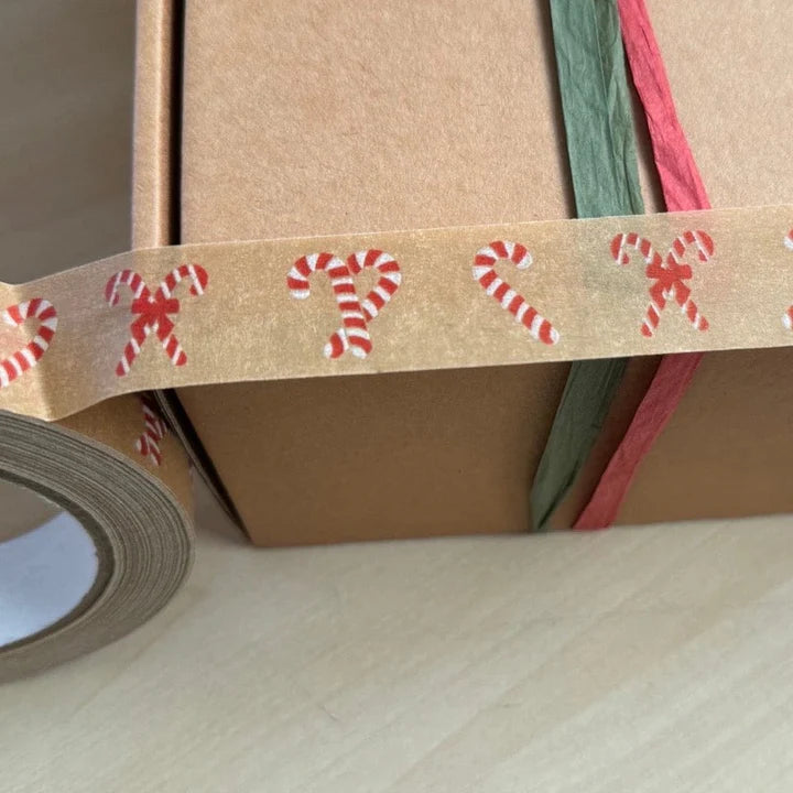 Decorative tape with candy cane design on a cardboard box