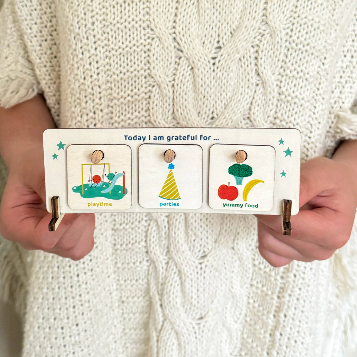 child holding Cotton Twist Wooden Gratitude Chart for Children with colourful wooden tokens to encourage children to be mindful 