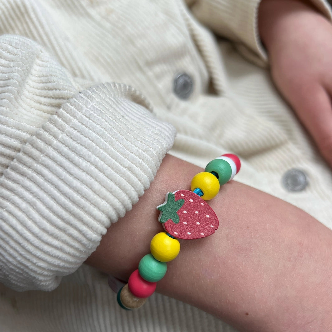 child wearing a completed cotton twist strawberry bracelet