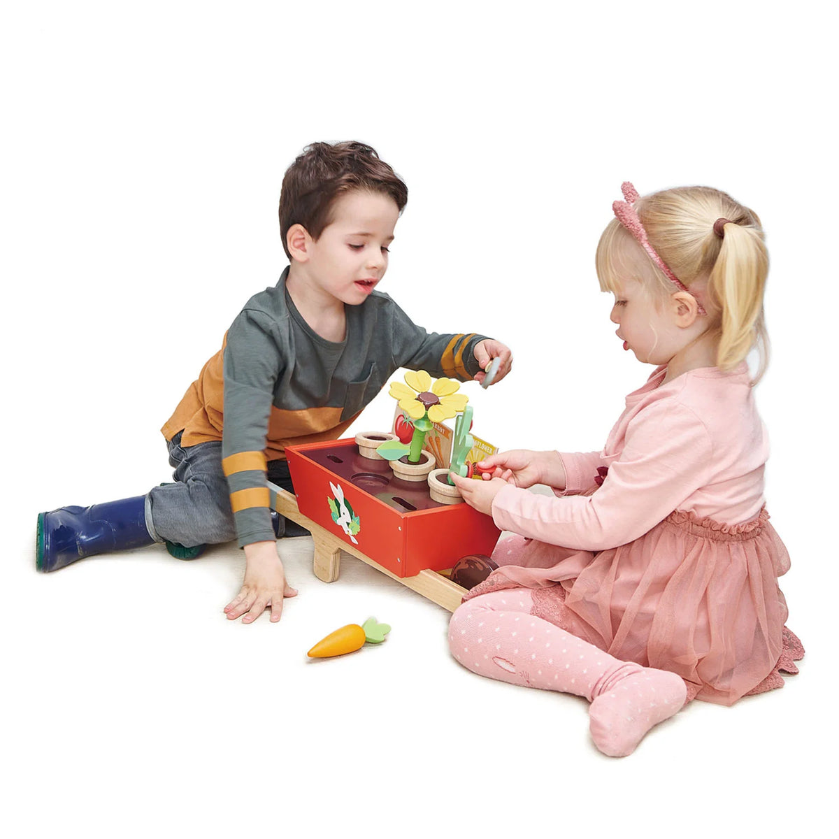 children playing with Tender Leaf wooden Garden Wheelbarrow Set for  age three and up