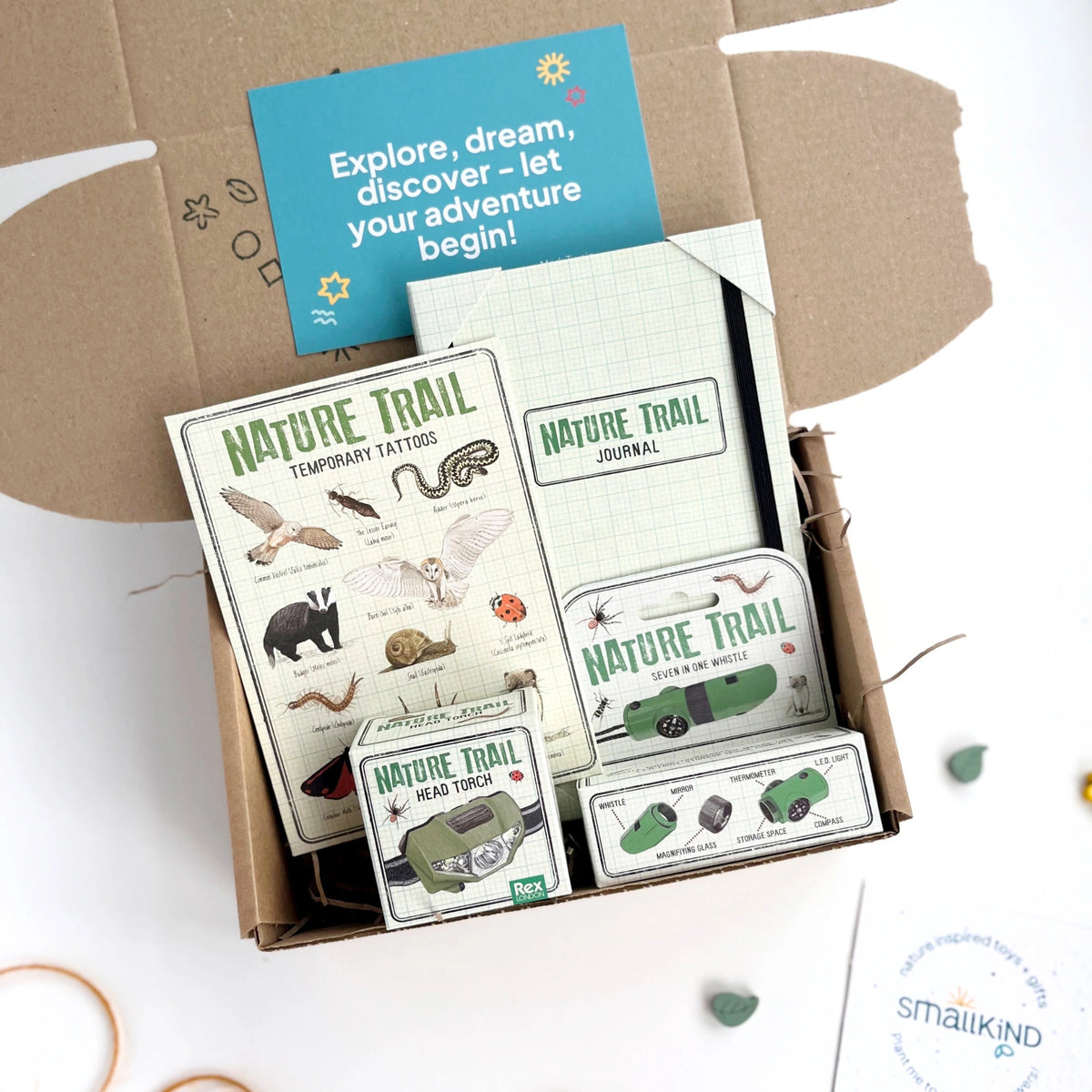 Kids nature themed gift box including a nature trail journal, animal temporary tattoos, a head torch, nature whistle and some stickers. 