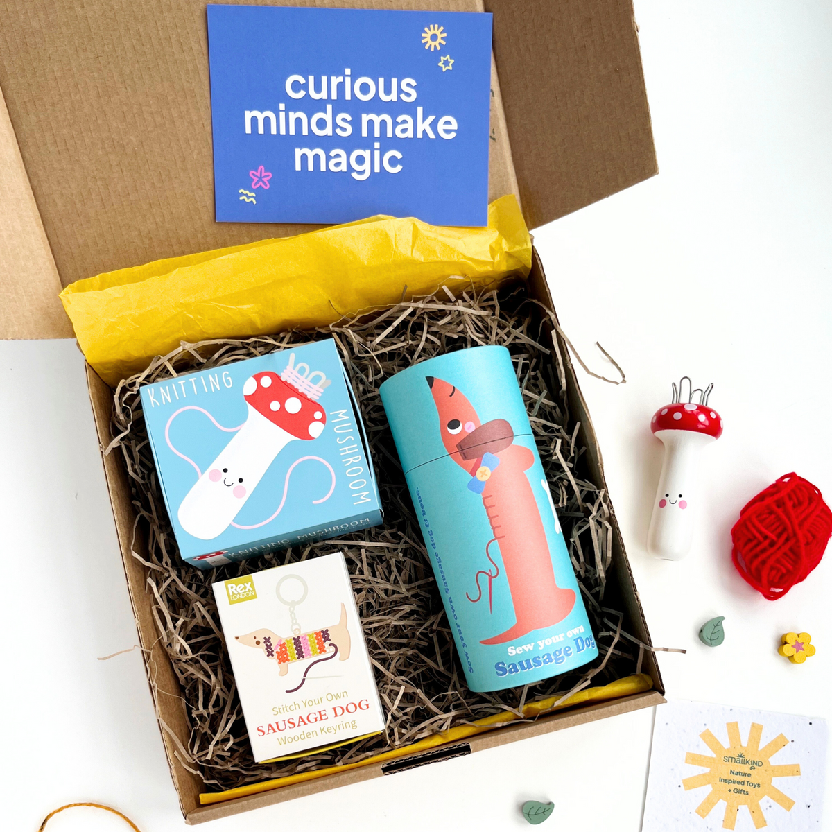 childrens sewing crafts gift box which includes a make your own keyring kit, sew your own sausage dog kit and a knitting mushroom with wool. for kids age 3+