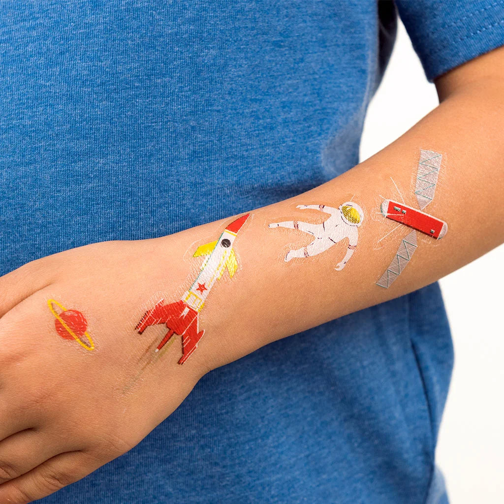 child's arm with colourful space themed temporary tattoos