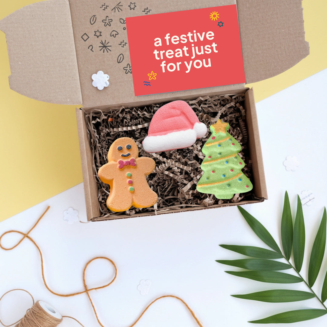 gift box with three festive bath bombs - gingerbread man, santa hat and christmas tree
