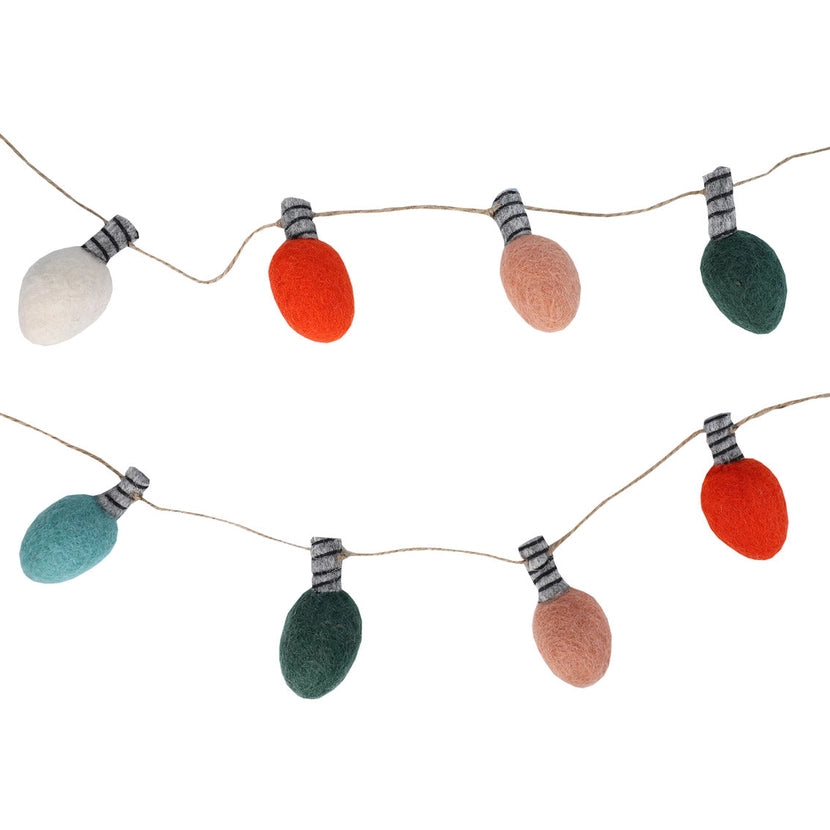 String of colourful Christmas felt lightbulb shapes on a white background