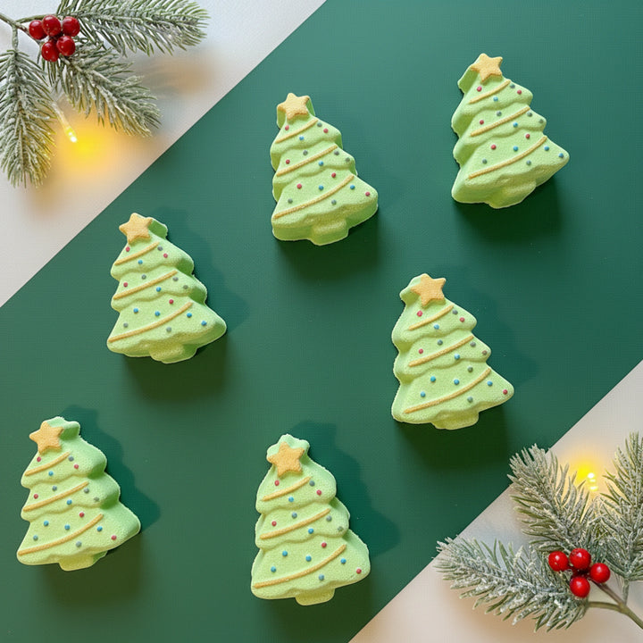 six christmas tree bath bombs on a green background with festive holly branches