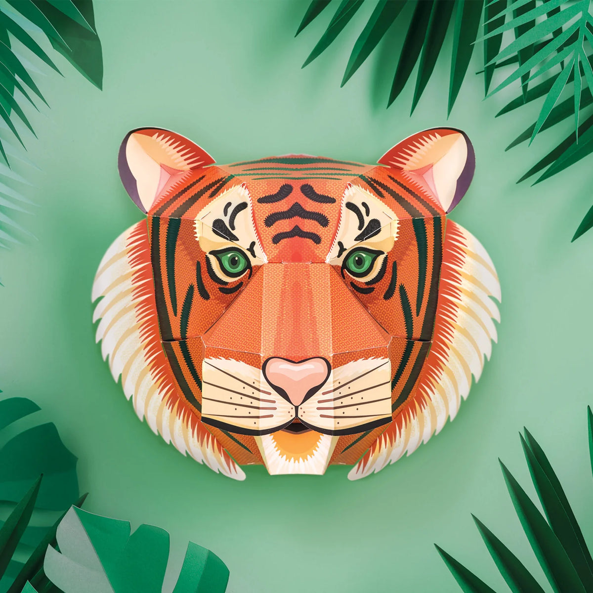 front view of Clockwork Soldier create your own tiger head craft kit with green leaves on a green wall