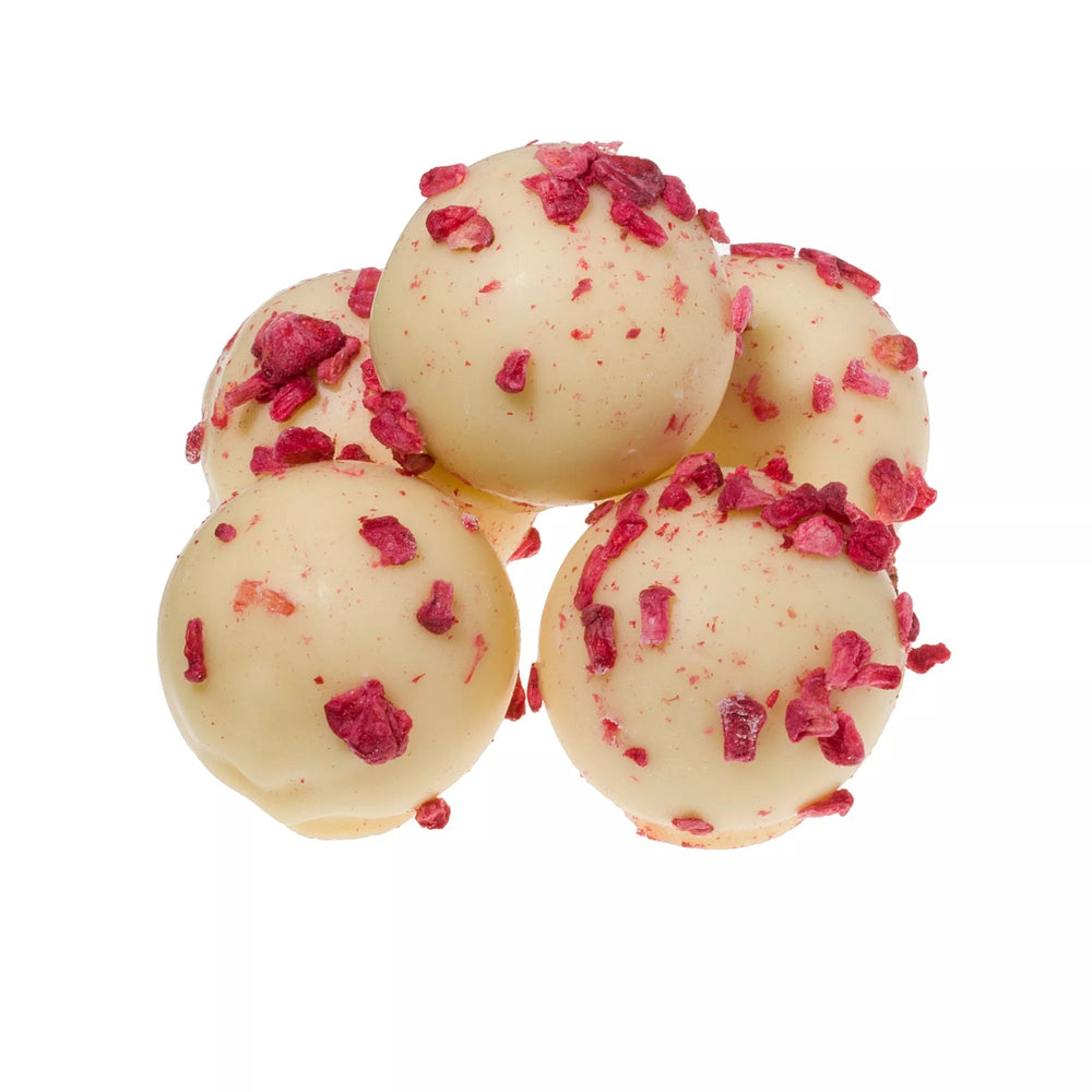 White chocolate raspberry and marc de champagne truffles truffles with pink toppings on a white background
