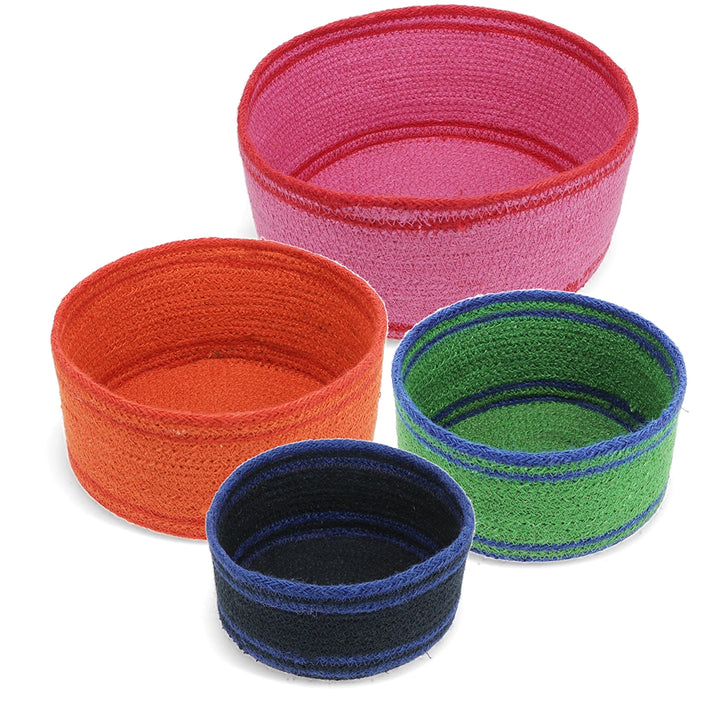 Set of 4 colourful woven bowls in pink, orange, green and blue on a white background
