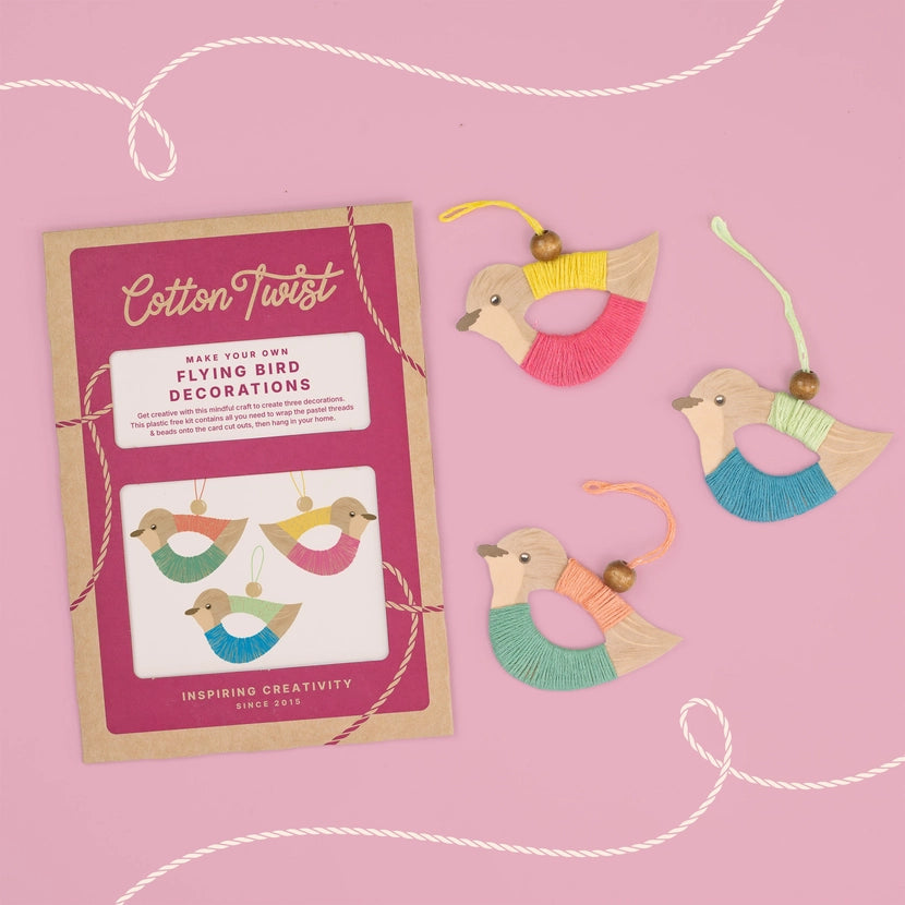 Cotton Twist flying bird decorations craft kit with colourful bird decorations on a pink background